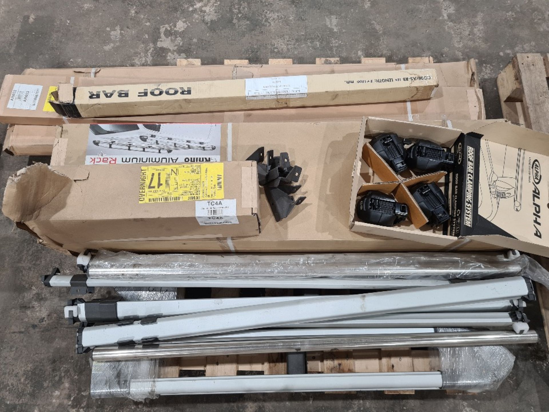 Pallet of various van roof bars, clamps and aluminium racks. Some new and unopened. Including 3.2m