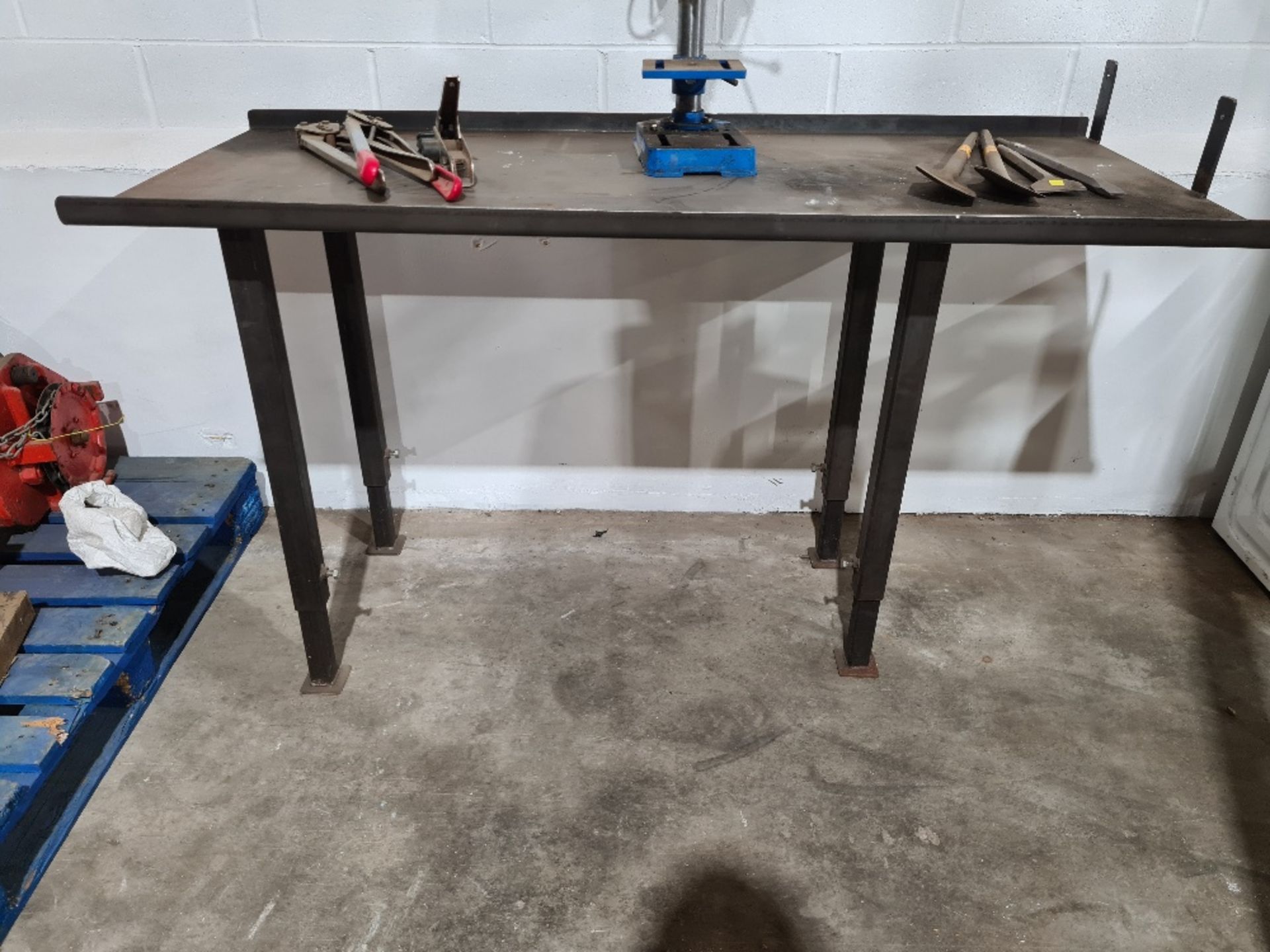 Heavy duty, adjustable height metal bench (contents not included).