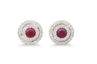 A PAIR OF DIAMOND AND RUBY CLUSTER EARRINGS, the circular rubies to two rowed diamond surrounds,