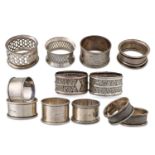 A MATCHED GROUP OF TWELVE STERLING SILVER NAPKIN RINGS, from the 19th & 20th Century, various