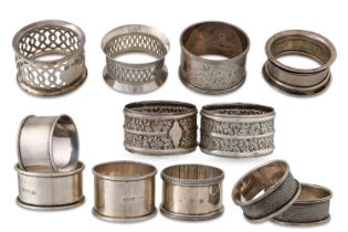 A MATCHED GROUP OF TWELVE STERLING SILVER NAPKIN RINGS, from the 19th & 20th Century, various