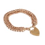 A 9CT GOLD CURB LINK BRACELET, with padlock clasp, 14.5 g.