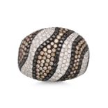 A DIAMOND BOMBE RING, the white and brown diamonds of abstract form, mounted in 18ct white gold,