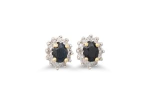 A PAIR OF DIAMOND AND SAPPHIRE CLUSTER EARRINGS, the oval sapphires to a diamond surround, mounted