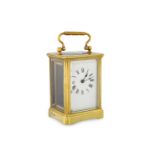 A 19th CENTURY BRASS FRAMED GLASS CARRIAGE CLOCK, with key, white enamel dial & Roman numerals, ca