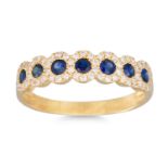 A DIAMOND AND SAPPHIRE SEVEN STONE RING, the circular sapphires to diamond shoulders, mounted in