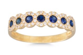 A DIAMOND AND SAPPHIRE SEVEN STONE RING, the circular sapphires to diamond shoulders, mounted in