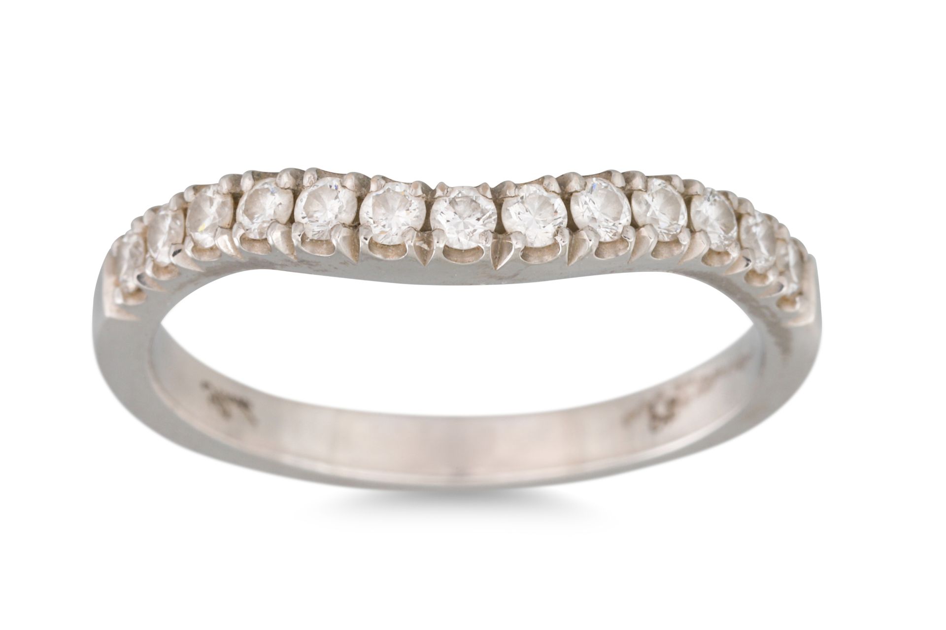A DIAMOND SET SHAPED BAND, in platinum. Estimated: weight of diamonds: 0.35 ct., size L