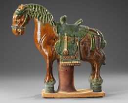 A CHINESE GREEN AND BROWN GLAZED HORSE, MING DYNASTY (1368-1644 AD)