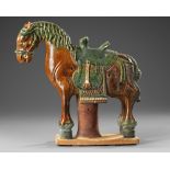 A CHINESE GREEN AND BROWN GLAZED HORSE, MING DYNASTY (1368-1644 AD)