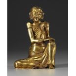 A GILT-BRONZE SEATED FIGURE OF THE ASCETIC SHAKYAMUNI, 17TH CENTURY