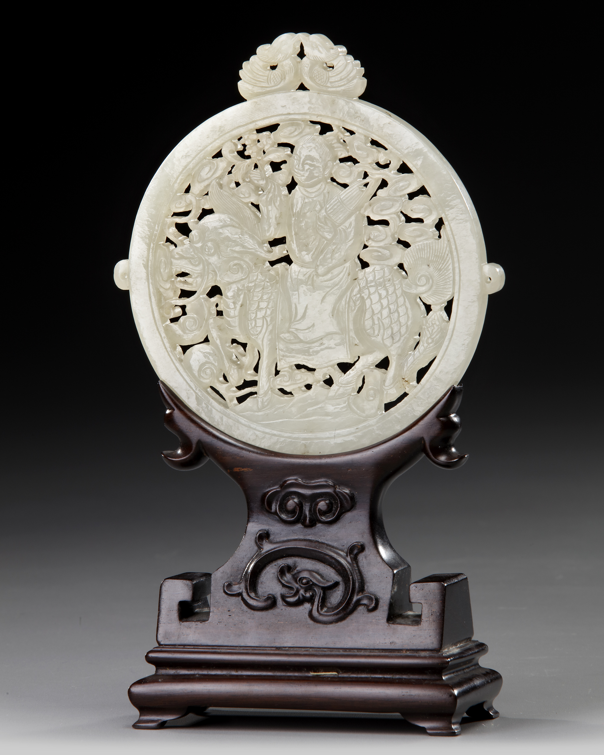 A CHINESE WHITE JADE ARCHAISTIC OPENWORK PLAQUE ON A WOODEN STAND, 19TH-20TH CENTURY