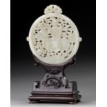 A CHINESE WHITE JADE ARCHAISTIC OPENWORK PLAQUE ON A WOODEN STAND, 19TH-20TH CENTURY