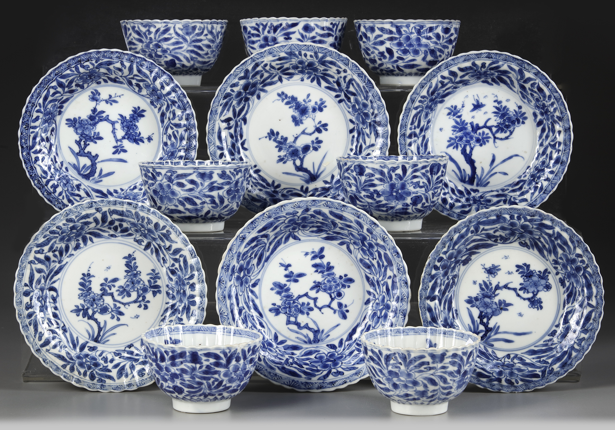 A SET OF SEVEN CHINESE BLUE AND WHITE CUPS AND SIX SAUCERS, KANGXI PERIOD (1662-1722)