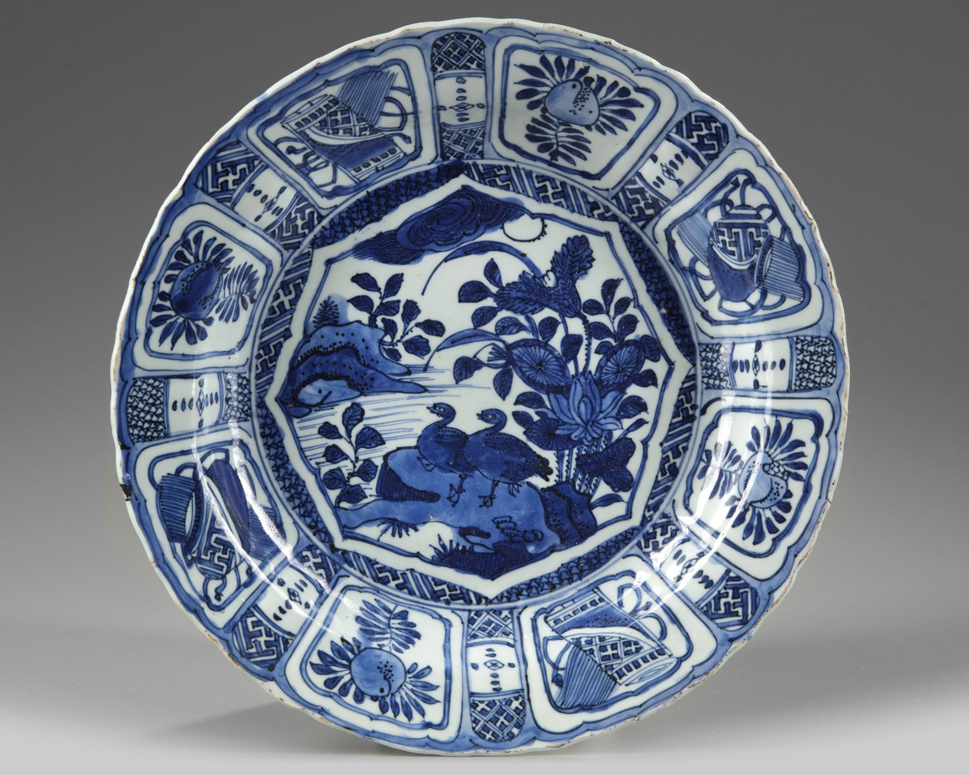 A CHINESE BLUE AND WHITE 'DUCKS AND LOTUS 'KRAAK PORSELEIN' DISH, WANLI PERIOD (1573-1619)