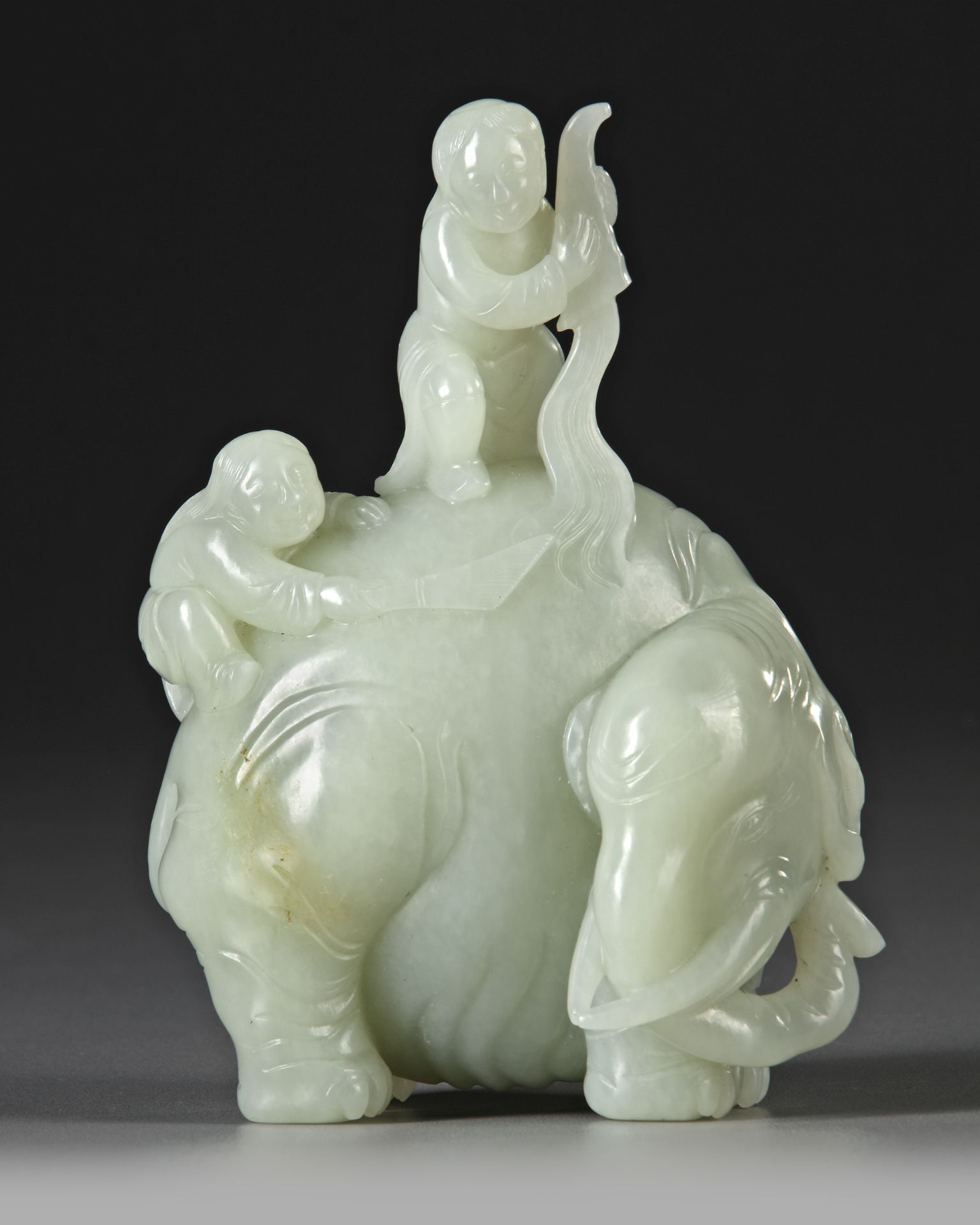 A CELADON JADE CARVING OF TWO BOYS WASHING AN ELEPHANT, 19TH CENTURY