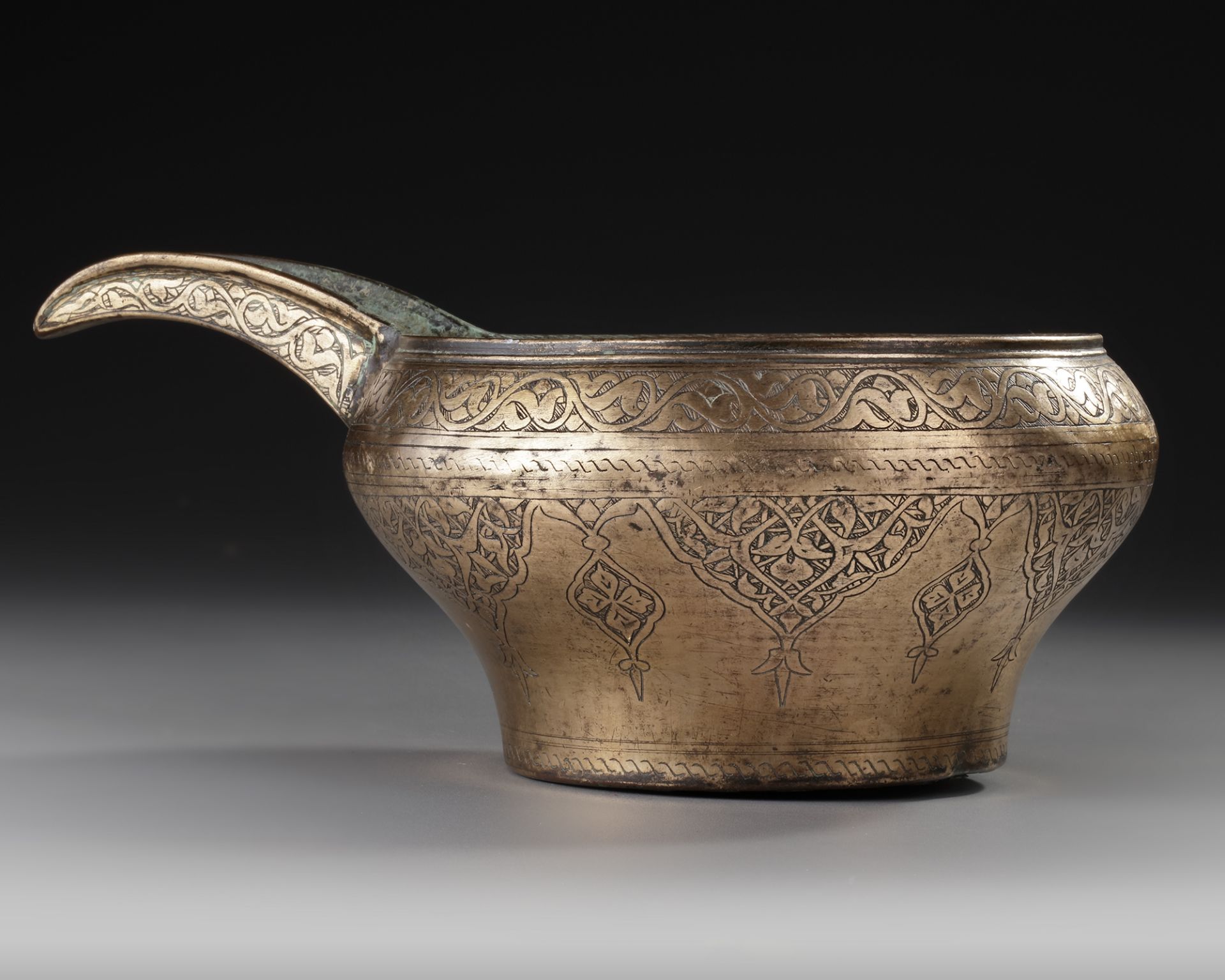 AN ENGRAVED SAFAVID TINNED COPPER SPOUTED POURING BOWL, PERSIA, 17TH CENTURY