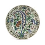 AN IZNIK POTTERY DISH WITH QUATRE FLEURS DECORATION, OTTOMAN TURKEY, 16TH CENTURY