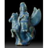 A SEATED FIGURINE ON A FLYING ANIMAL, RAQQA, SYRIA, 12TH-13TH CENTURY