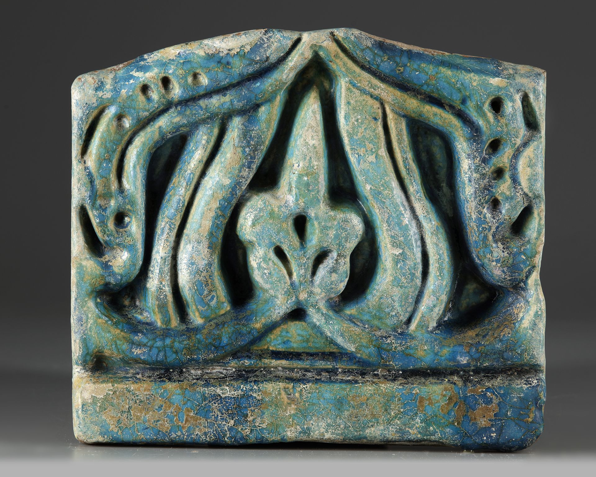 A FINE RAQQA TURQUOISE GLAZED POTTERY TILE, SYRIA, LATE 12TH CENTURY