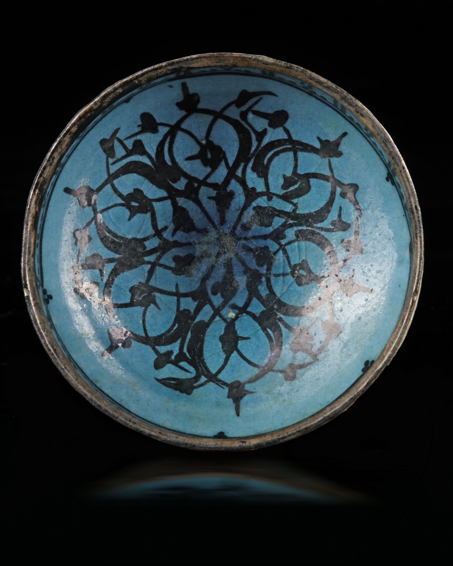 A KASHAN TURQUOISE AND BLACK DECORATED BOWL, PERSIA, 13TH CENTURY