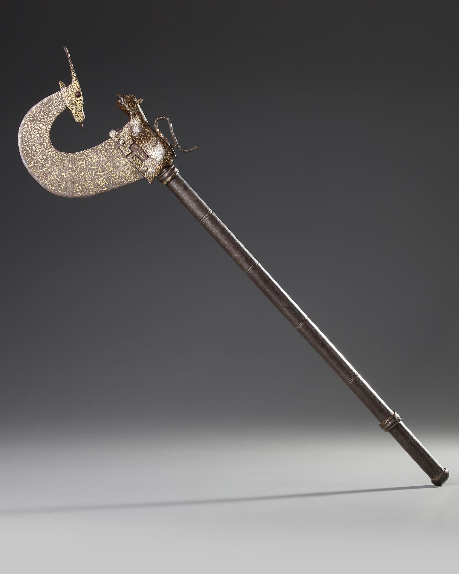 A CEREMONIAL GOLD-DAMASCENED STEEL AXE, INDIA DATED 1120 AH/1708 AD