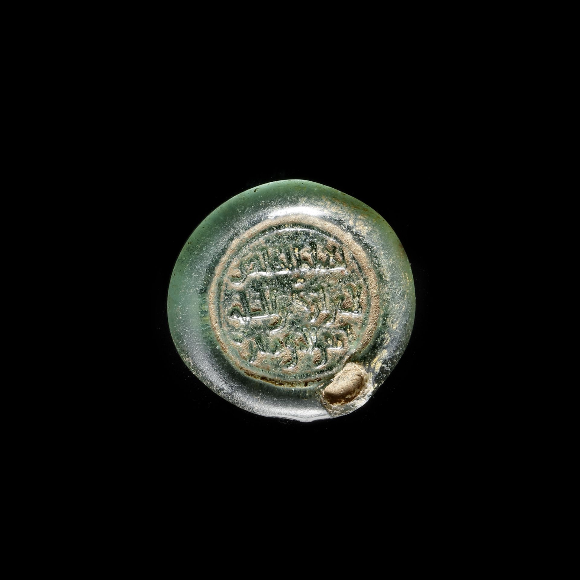 A FATIMID GLASS WEIGHT OF A DIRHAM, EGYPT AL-ZAHIR DATED 414 AH/1023 AD