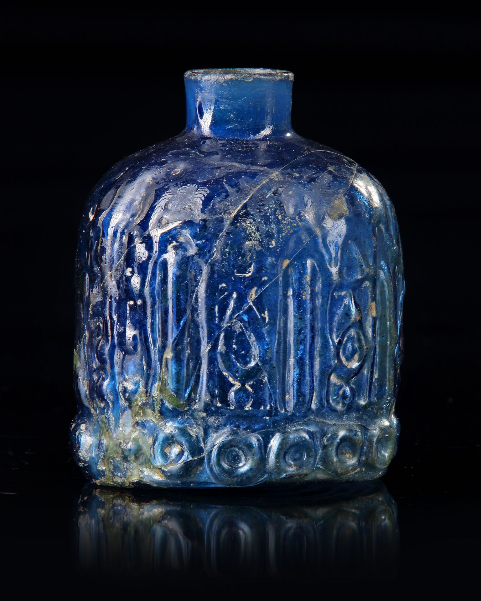 A BLUE GLASS BOTTLE, MESOPOTAMIAN REGION, 10TH CENTURY