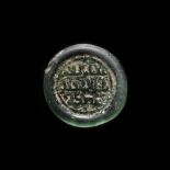 A FATIMID GLASS WEIGHT OF DIRHAM, EGYPT AL-HAKIM BI-AMR ALLAH (386AH-411AH/ 996AD-1021AD)