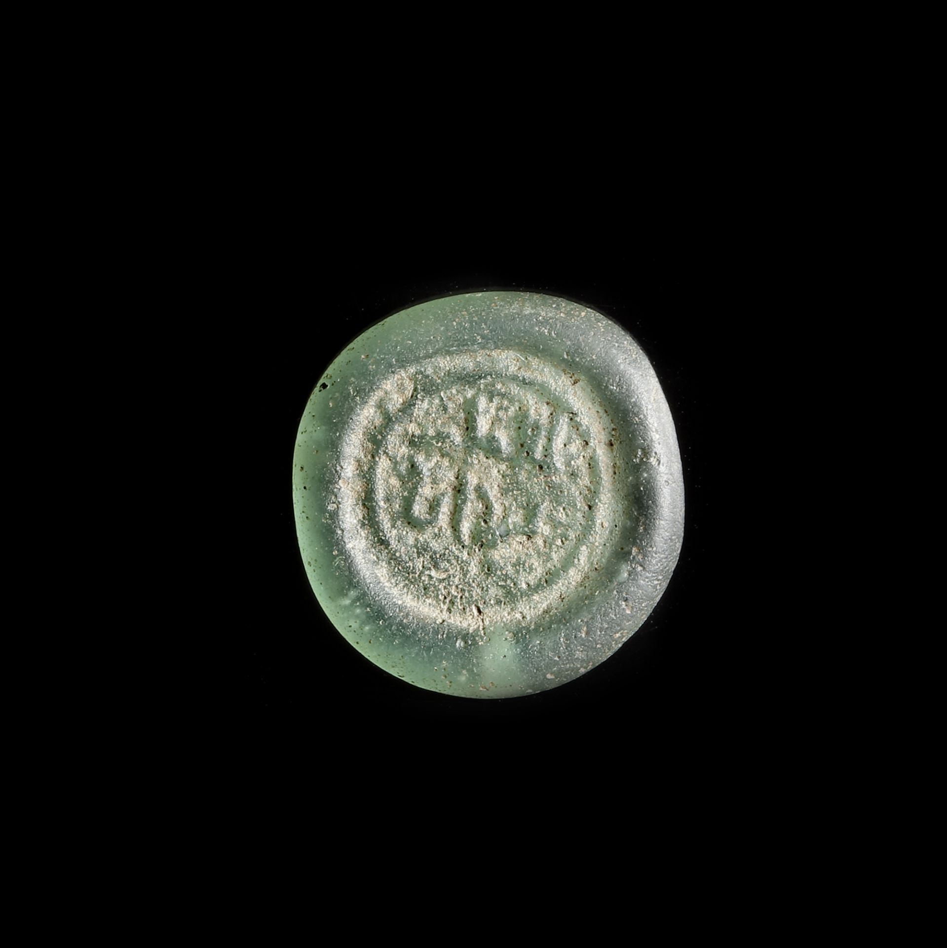 A FATIMID GLASS WEIGHT OF DIRHAM, EGYPT AL-AZIZ BILLAH ( 364-386 AH/ 975-996 AD)