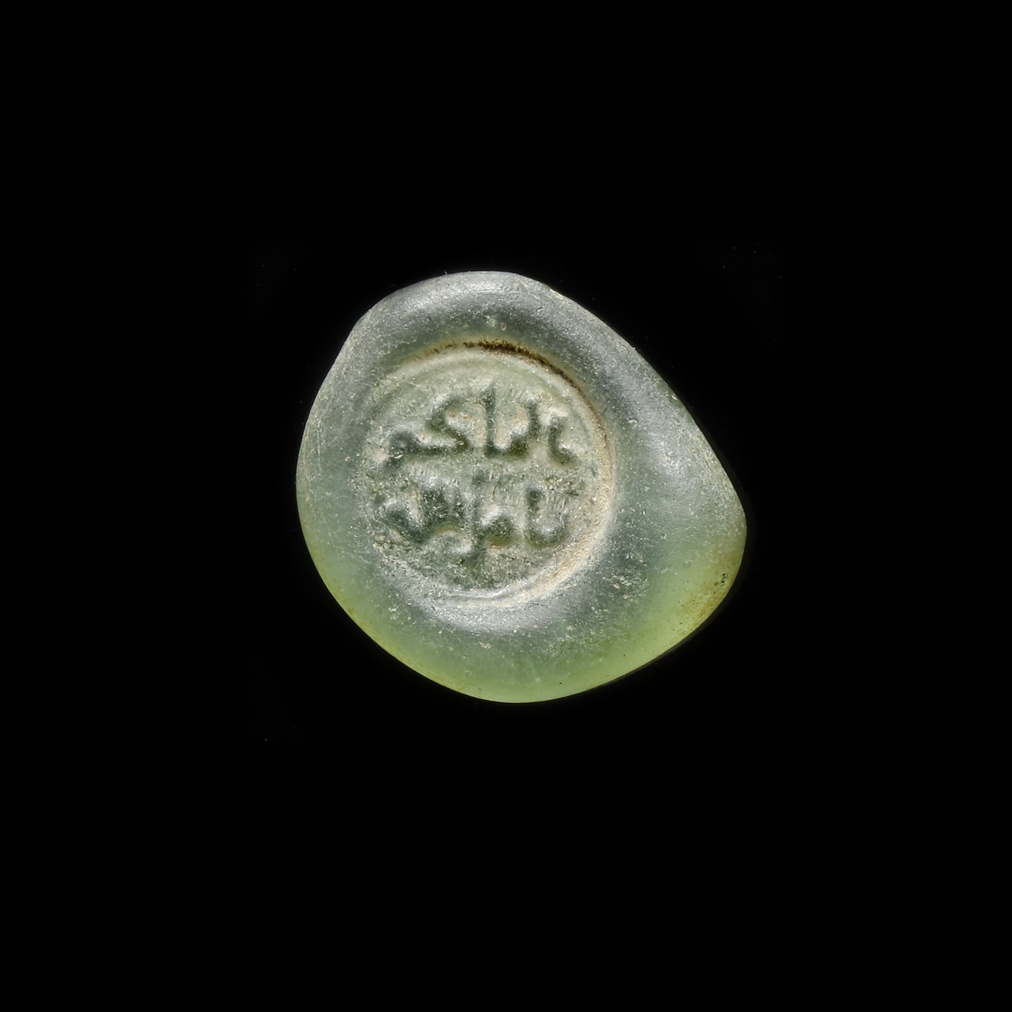 A FATIMID GLASS WEIGHT OF DIRHAM, EGYPT AL-HAKIM BI-AMR ALLAH (386AH-411AH/ 996AD-1021AD)