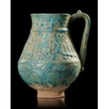 A TURQUOISE GLAZED POTTERY EWER, PROBABLY NISHAPUR, 12TH CENTURY