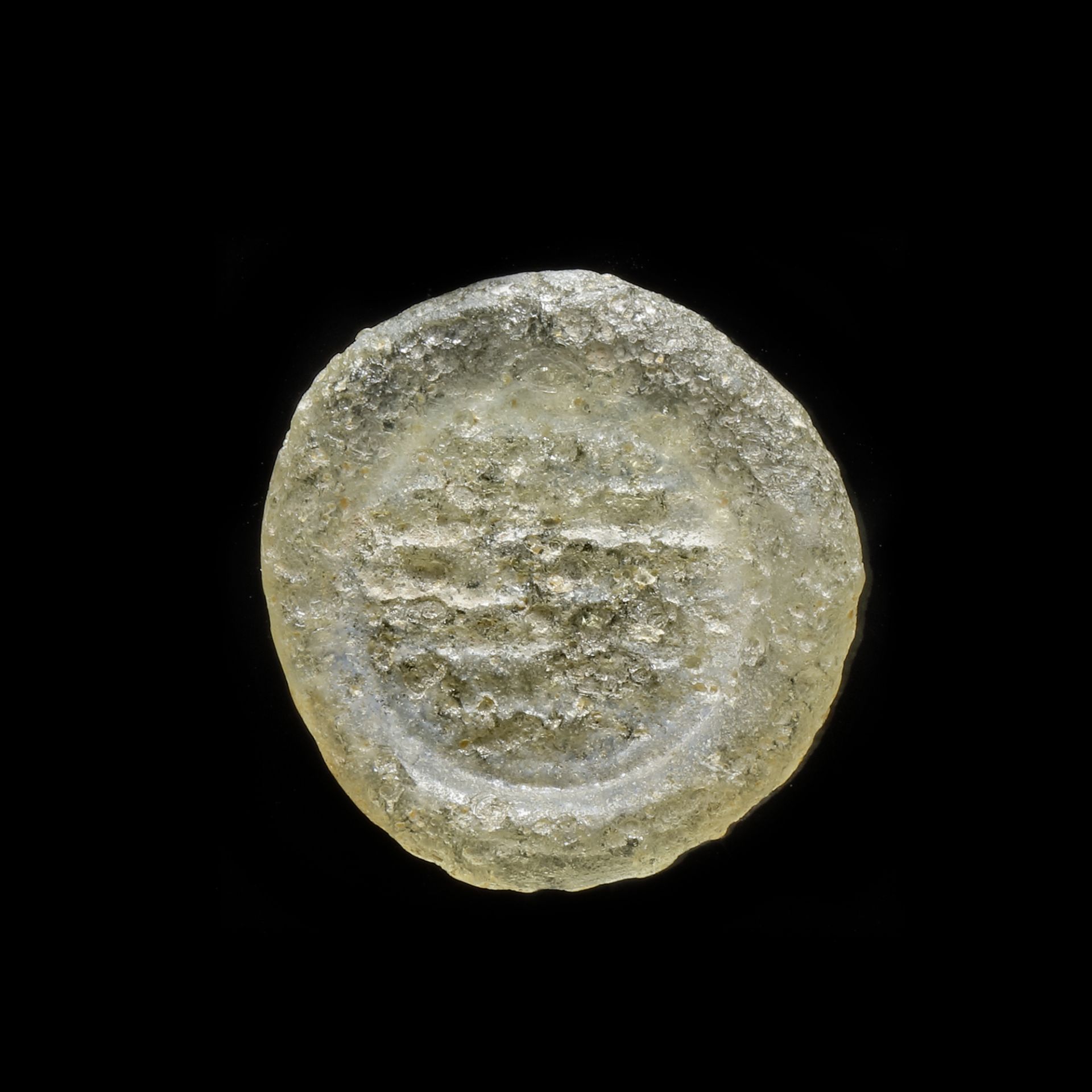 A FATIMID GLASS WEIGHT OF DOUBLE DIRHAM, EGYPT 10TH-11TH CENTURY
