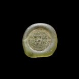 A FATIMID GLASS WEIGHT OD DOUBLE DIRHAM, AL-MUSTANSIR BI-ALLAH (AH 427-487 / 1036-1094 AD),