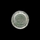 A FATIMID GLASS WEIGHT OF DOUBLE DINAR, EGYPT AL-MUSTANSIR BI-ALLAH (AH 427-487 / 1036-1094 AD)