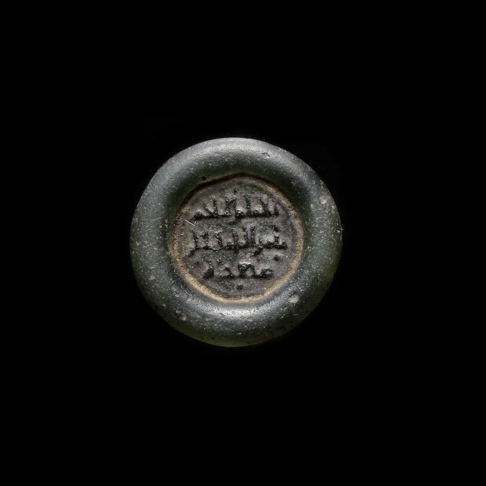 A FATIMID GLASS WEIGHT OF DOUBLE DIRHAM, EGYPT AL-HAKIM BI-AMR ALLAH (386AH-411AH/ 996AD-1021AD)