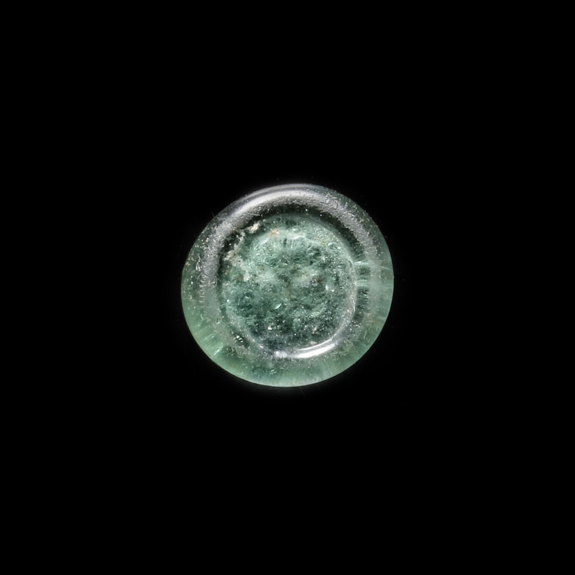 A FATIMID GLASS WEIGHT OF QUARTER DIRHAM, EGYPT AL-MUSTANSIR BI-ALLAH (AH 427-487 / 1036-1094 AD)