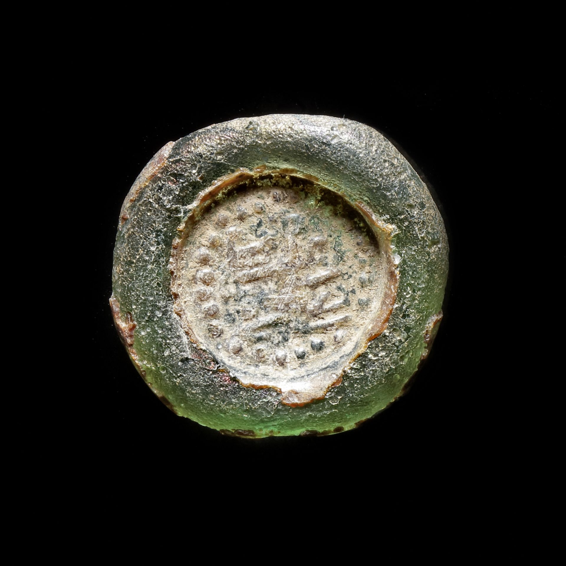 A FATIMID GLASS WEIGHT OF FALS, EGYPT AL-HAKIM BI-AMR ALLAH (386AH-411AH/ 996AD-1021AD)