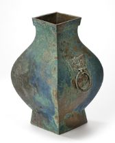 A CHINESE BRONZE SQUARE-SECTION TWIN-HANDLED HU VASE, HAN DYNASTY (206 BC-220AD)