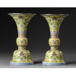 A PAIR OF CHINESE YELLOW-GROUND FAMILLE ROSE GU VASES, QING DYNASTY (1644-1911)