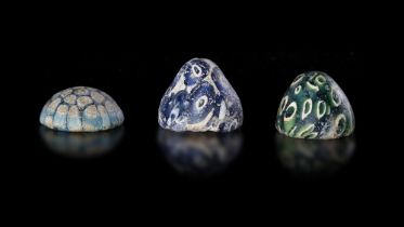 THREE COBALT-BLUE, GREEN AND TURQUOISE GLASS GAMES PIECES, MESOPOTAMIAN REGION, 8TH-9TH CENTURY