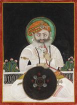 A PORTRAIT OF A RAJA SMOKING A HUQQA MEWAR, NORTH INDIA, MID-19TH CENTURY