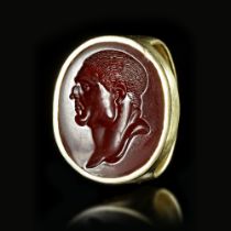 A ROMAN GOLD RING WITH A CARNELIAN INTAGLIO WITH THE PORTRAIT OF A MAN, 1ST BC/AD