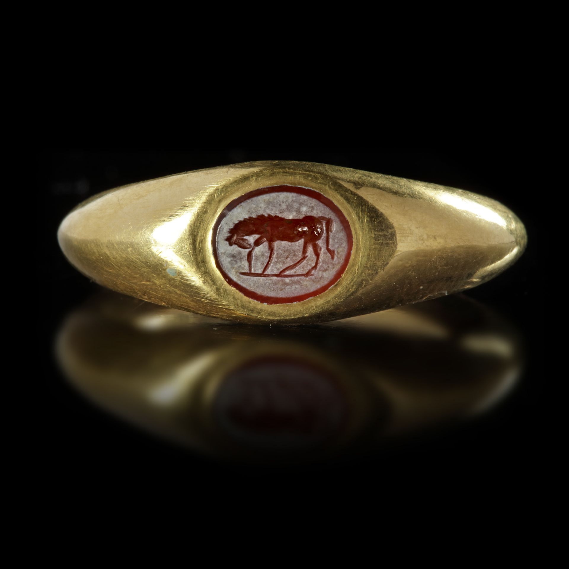 A ROMAN GOLD RING WITH AN INTAGLIO OF A HORSE, 1ST CENTURY AD