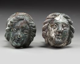 A PAIR OF ROMAN BRONZE AND SILVERED "FACE OF FEMALE" TERMINALS, CIRCA 2ND-3RD CENTURY AD