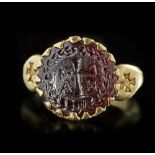 A BYZANTINE GOLD RING SET WITH A GARNET INTAGLIO, 6TH CENTURY AD OR LATER
