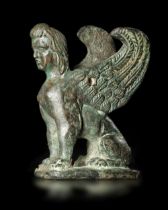 A SEATED BRONZE SPHINX, HELLENISTIC, 1ST-2ND CENTURY BC