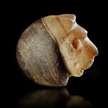 A STAMP SEAL IN THE FORM OF A LION'S HEAD IN BANDED CALCITE, 3RD MILLENNIUM BC