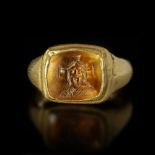 A BYZANTINE GOLD RING WITH A TOPAZ INTAGLIO WITH A BUST OF CHRIST, 6TH/7TH CENTURY AD