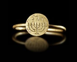 A BYZANTINE GOLD RING WITH MENORAH, 6TH-7TH CENTURY AD